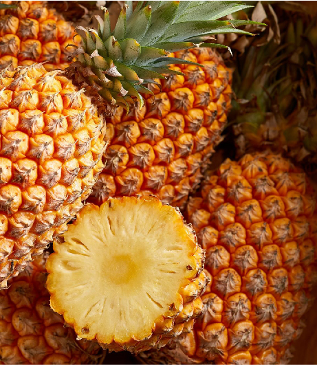 A stack of pineapples next to each other, one cut in half to show the fruit, representing the products of Southlander, Wholesale Flowers Near Me and Bulk Organic Food Produce Distributors.
